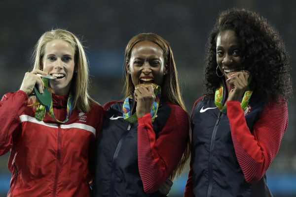 United States' gold medal winner Dalilah Muhammad is flanked by Denmark's silver medal winner Sara Slott Petersen