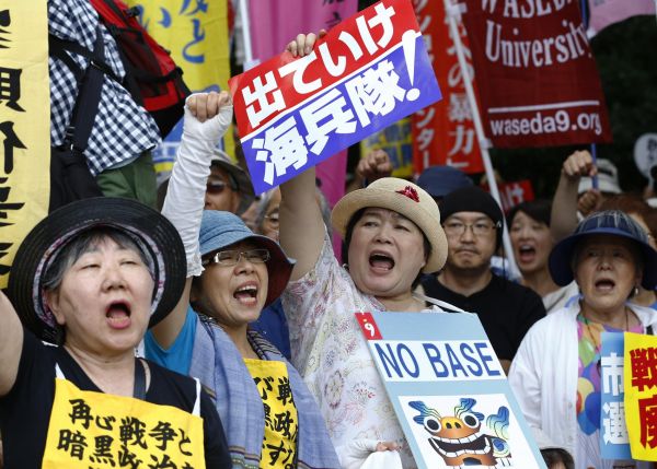 Anti-U.S. base protesters shouts slogans at a rally in front of the National Diet building  in Sunday