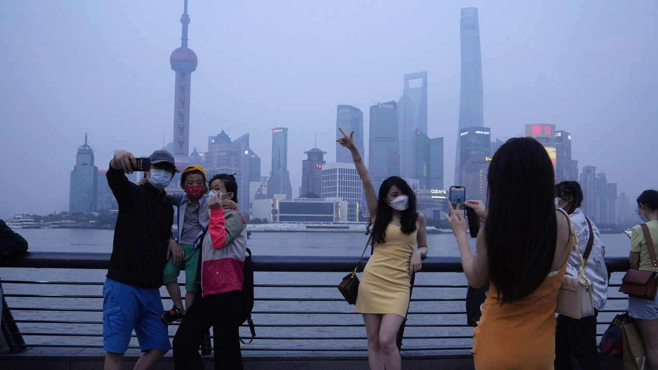 Residents pose for photos along the bund