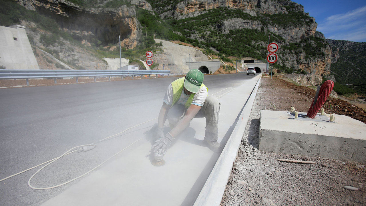 Worker levels a drain channel on Bar-Boljare highway in Gornje Mrke