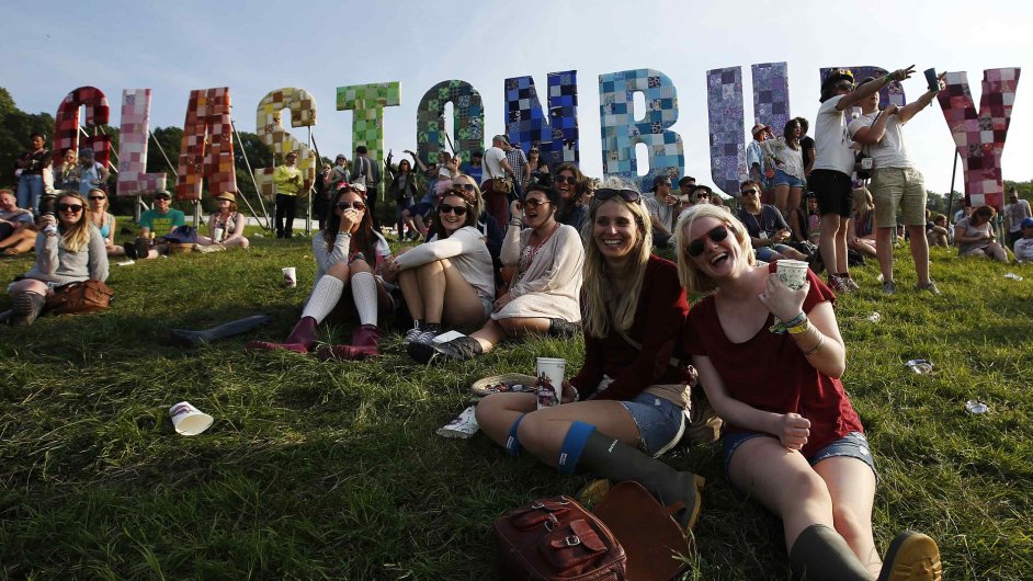 Festival goers watch their friends play rounders on the first day of Glastonbury music festival at Worthy Farm in Somerset