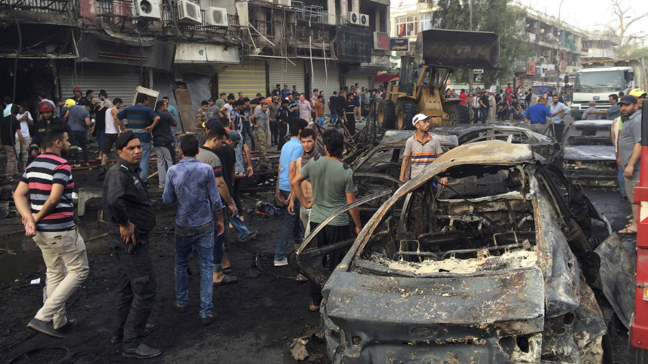 Iraqi security forces and civilians gather at the site after a car bomb at a commercial area in Karada neighborhood