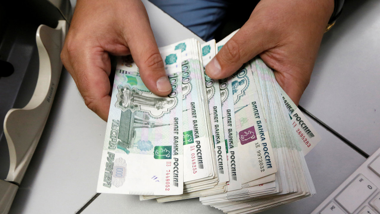 FILE PHOTO: An employee counts Russian ruble banknotes at a private companys office in Krasnoyarsk