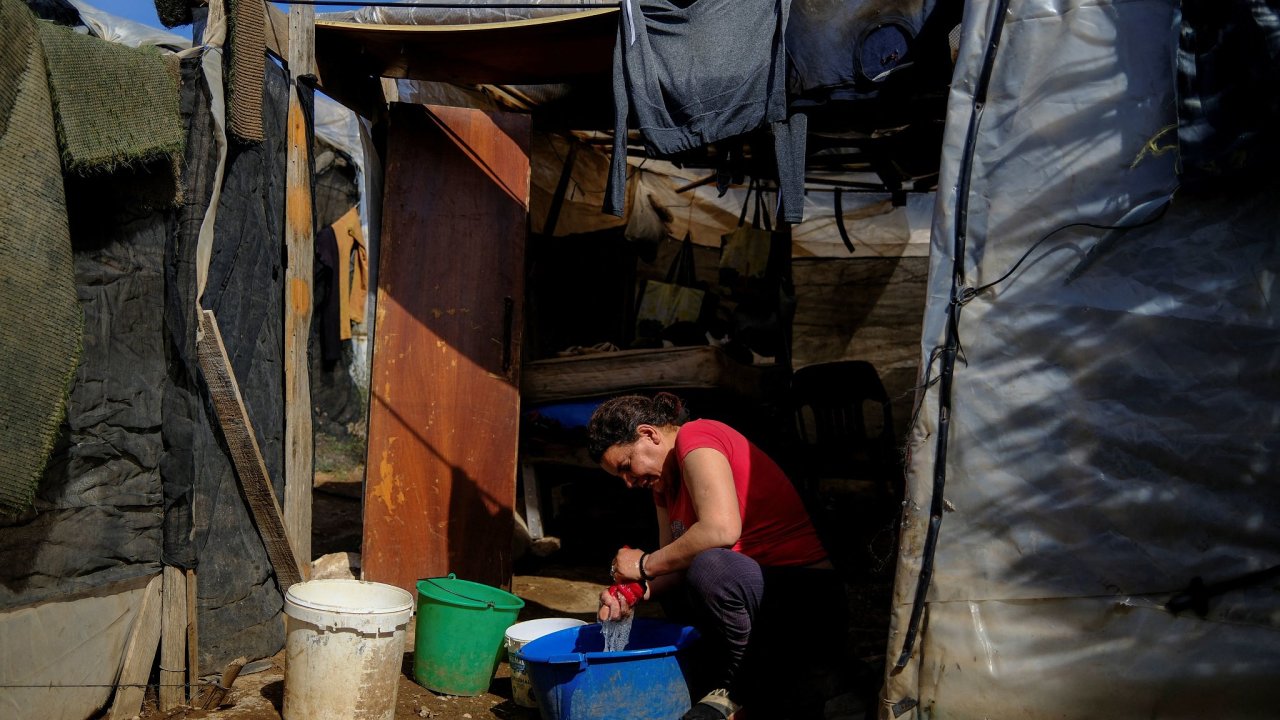 Neleg�ln� migrantka z Maroka si pere pr�dlo u provizorn�ch obydl� ve...