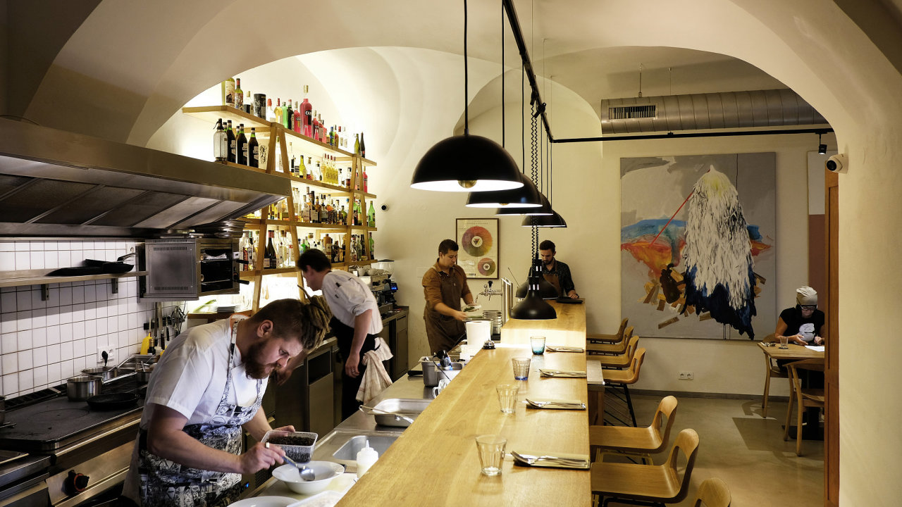 Atelier bar & bistro Kromě ke klasickým stolkům zde můžete usednout i přímo na bar a z první ruky pozorovat cvrkot mezi barmany a kuchaři.
