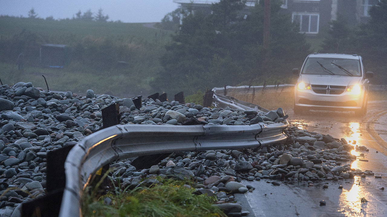 A guard rail was damaged by powerful waves that drove rocks on shore in Cow Bay