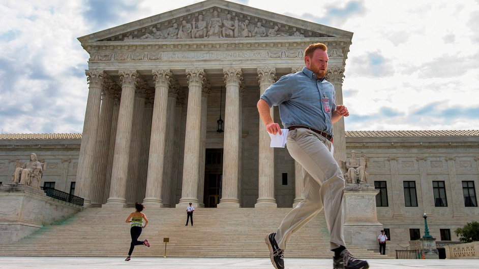 TV news assistants run to deliver copies of the Supreme Court's ruling that Obamacare tax credits can go to residents of any state