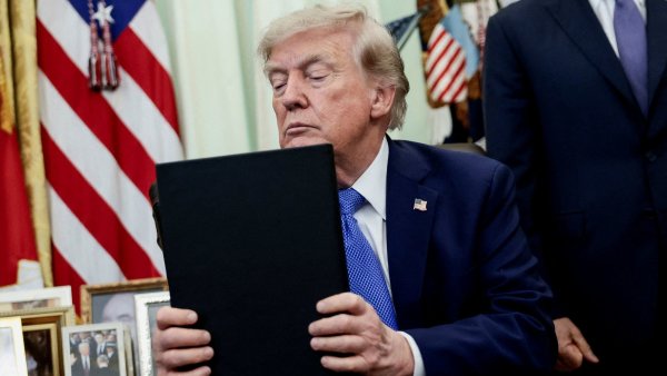 FILE PHOTO: U.S. President Donald Trump signs executive orders at the Oval...