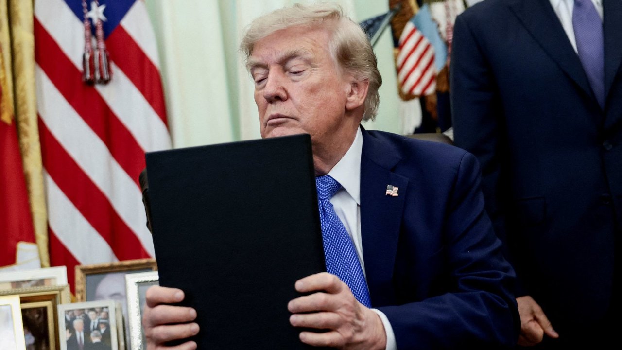 FILE PHOTO: U.S. President Donald Trump signs executive orders at the Oval...