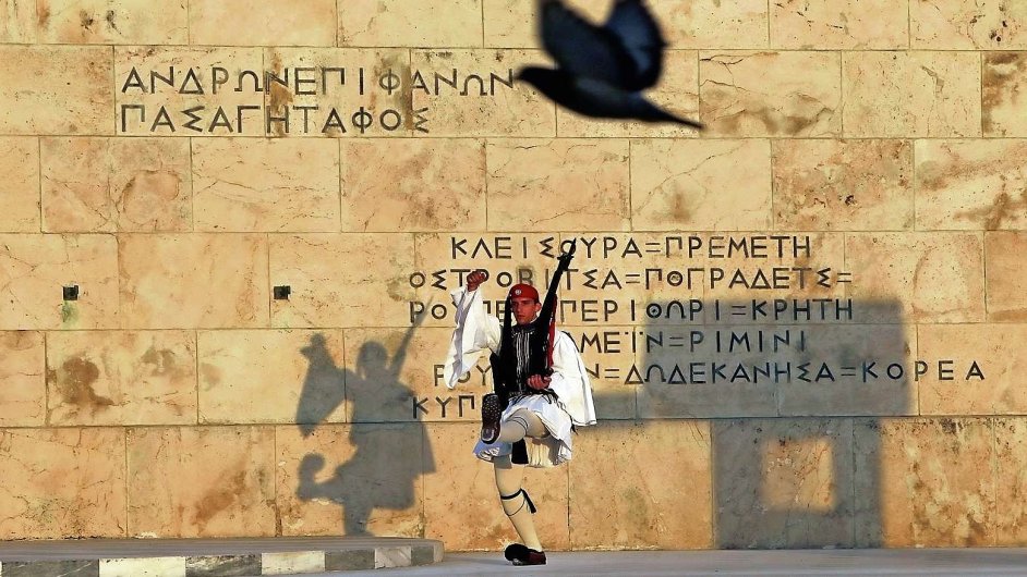 A Greek presidential guard marches at the Tomb of the Unknown Soldier in front of the parliament