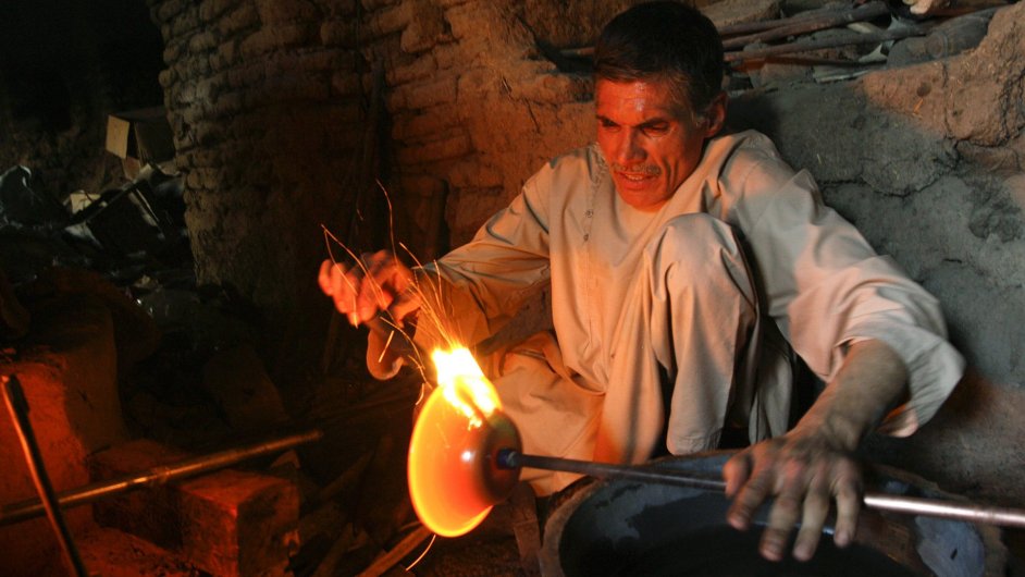 A glass maker works at his small workshop in Herat province