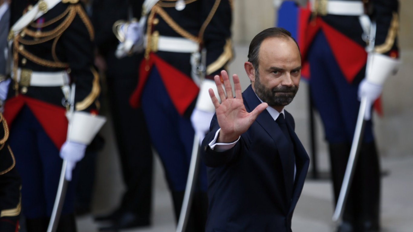 Newly appointed French Prime Minister Edouard Philippe waves after the handover ceremony with outgoing Prime Minister Bernard Cazeneuve in Paris