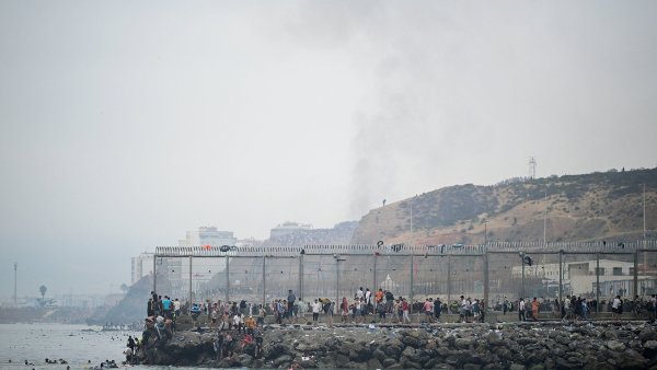 Migrants cross the border swimming through the sea, in Ceuta