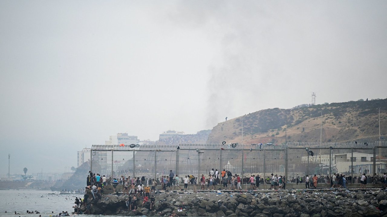 Migrants cross the border swimming through the sea, in Ceuta