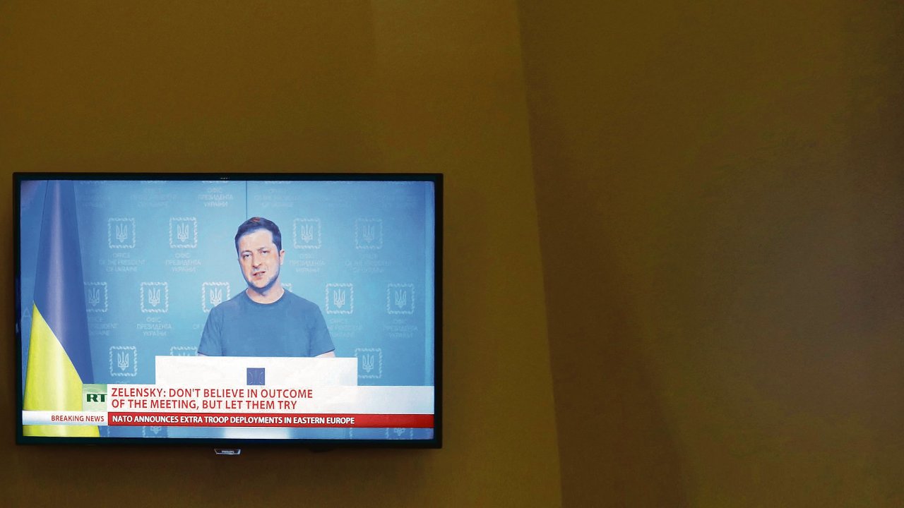 Ukrainian President Volodymyr Zelenskiy is seen on a TV screen in a hotel during a live news broadcast of the Russia Today (RT) channel TV