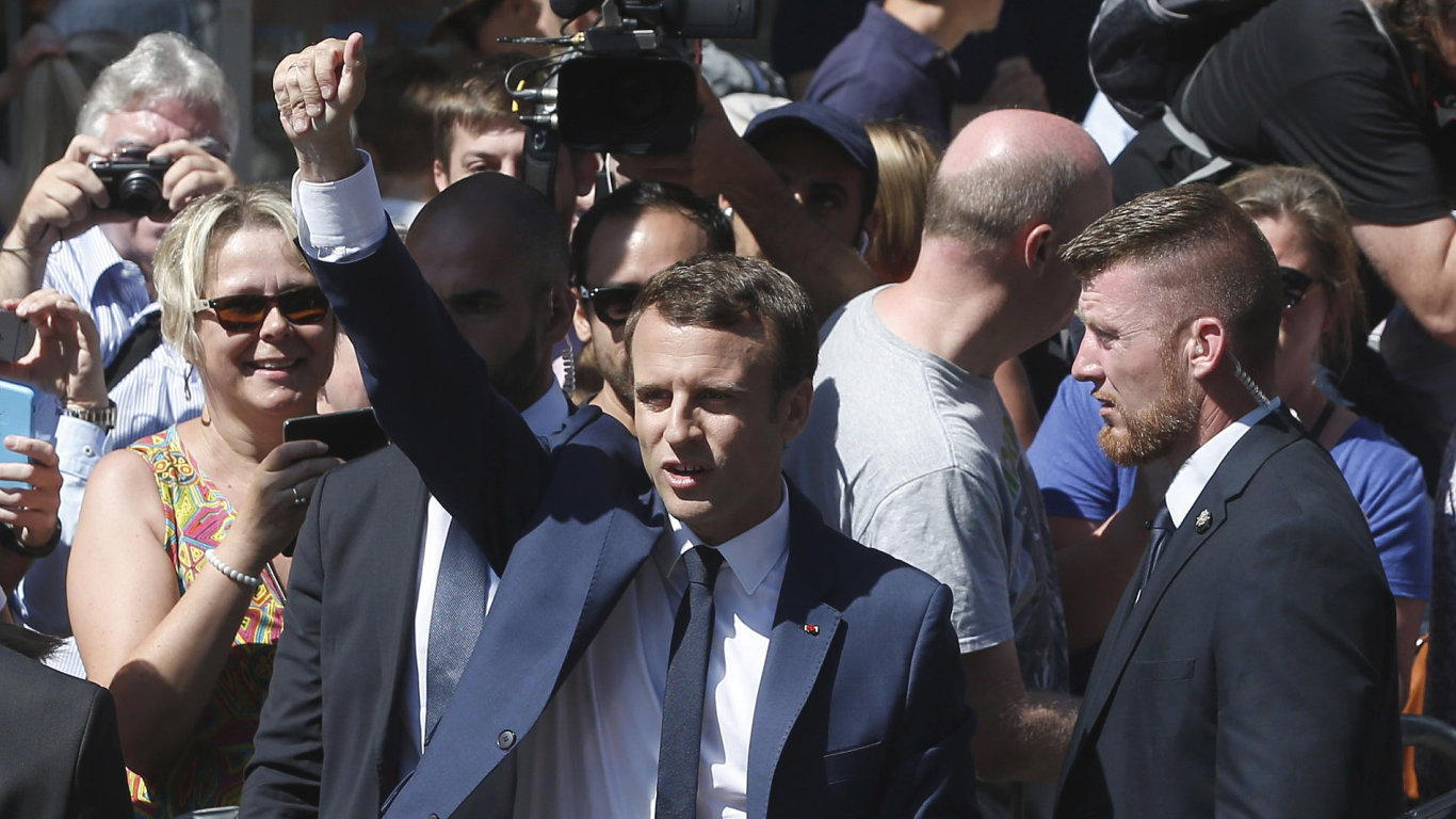 French President Emmanuel Macron waves as he leaves his house in Le Touquet