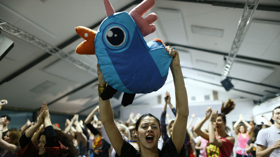 A reveller holds up a stuffed toy as she dances at Morning Glory