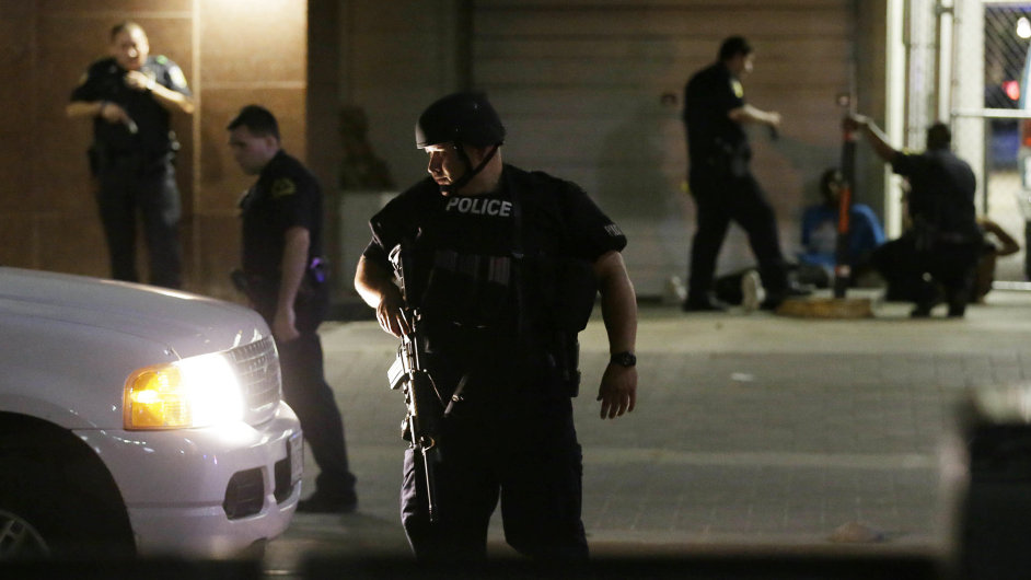 Dallas police detain a driver after a shooting in downtown Dallas