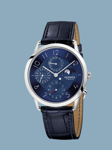 Hodinky Slim d’Hermès Quantième Perpétuel Platine jsou prvním modelem, který celý vznikl v rámci domu HERMÈS. Platinové pouzdro ukrývá ukazatel měsíční fáze i věčný kalendář.